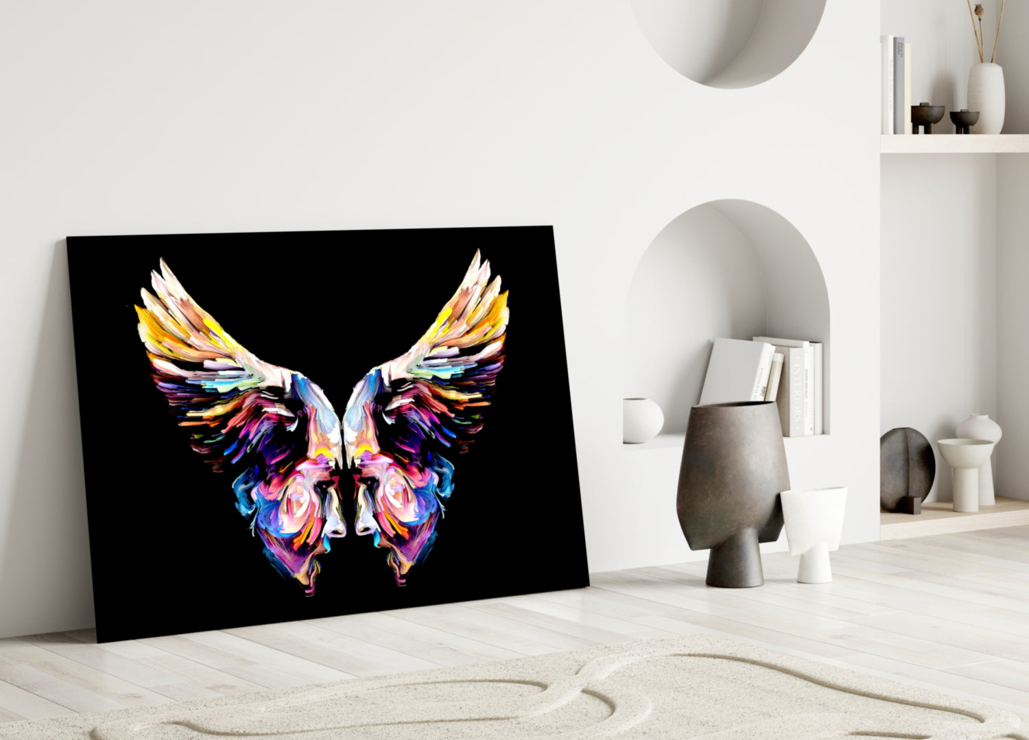 Colorful abstract butterfly artwork with vibrant wings displayed on black glass leaning against white wall in minimalist interior setting.