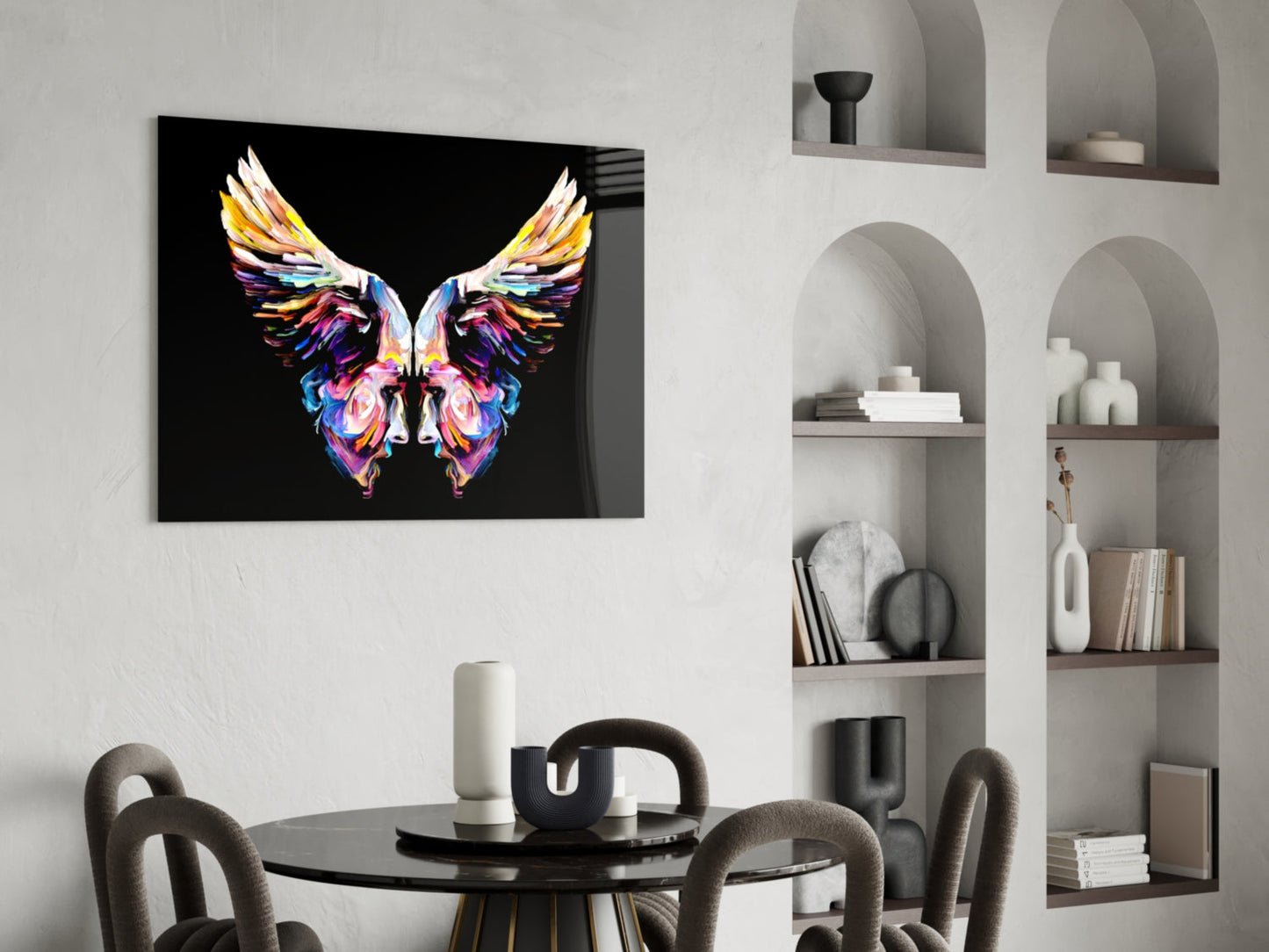 Colorful butterfly glass wall art with vibrant wings displayed above a black dining table in a modern interior setting.