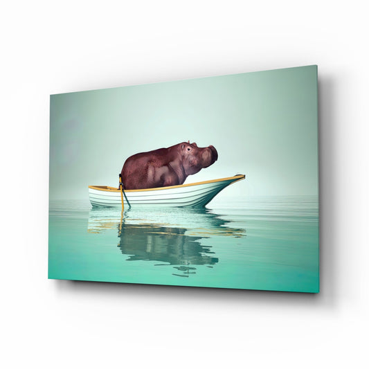 Glass wall art panel displayed at an angle showing a hippo in a striped yellow and white boat on turquoise water.