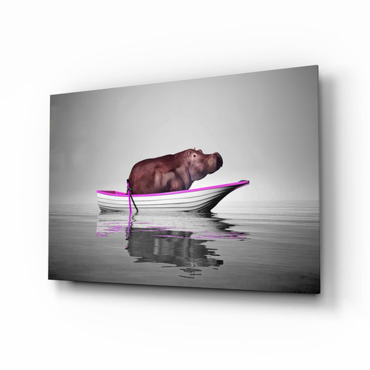 Angled perspective of glass wall art showing hippo resting in magenta-trimmed white boat on calm gray water with reflection.
