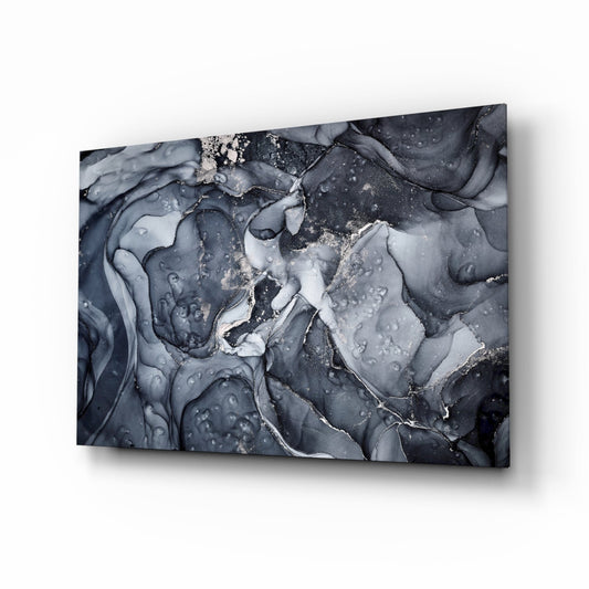 Gray smoke glass wall art displayed at an angle showing swirling dark gray and white fluid patterns with metallic accents.