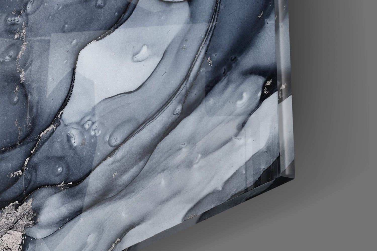 Close-up detail of gray smoke glass wall art showing swirled charcoal and white layered patterns with metallic gold accents.