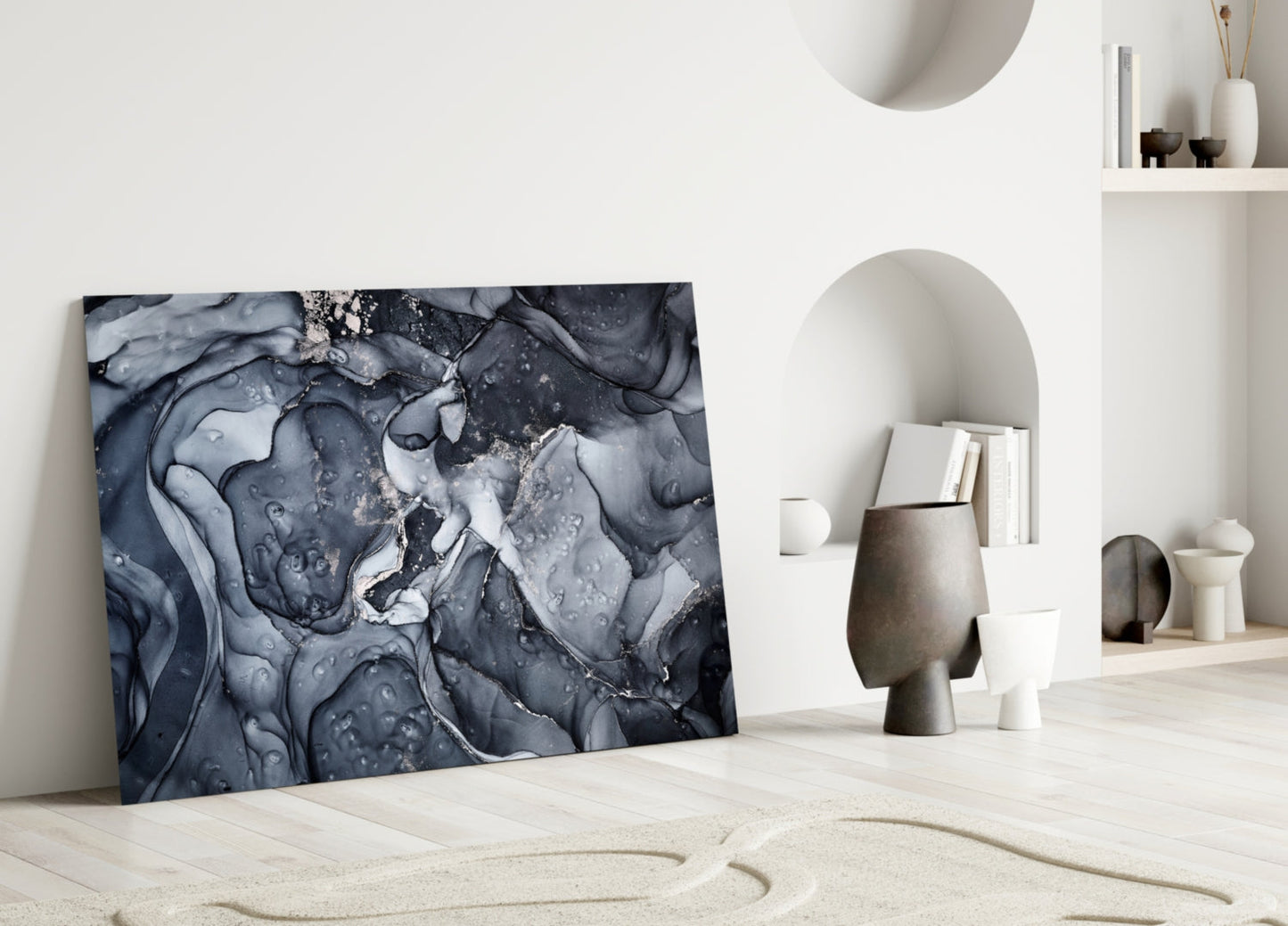 Gray Smoke Glass Wall Art leaning against white wall in minimalist interior with sculptural ceramics and shelving.