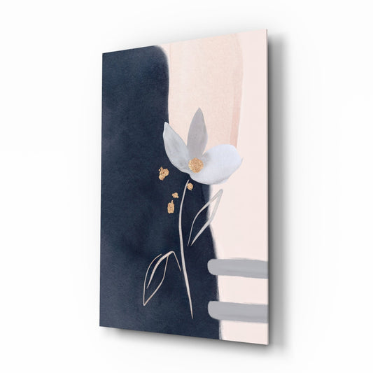 Angled view of glass wall art featuring a white flower with gold center on navy and blush background with gold leaf accents.