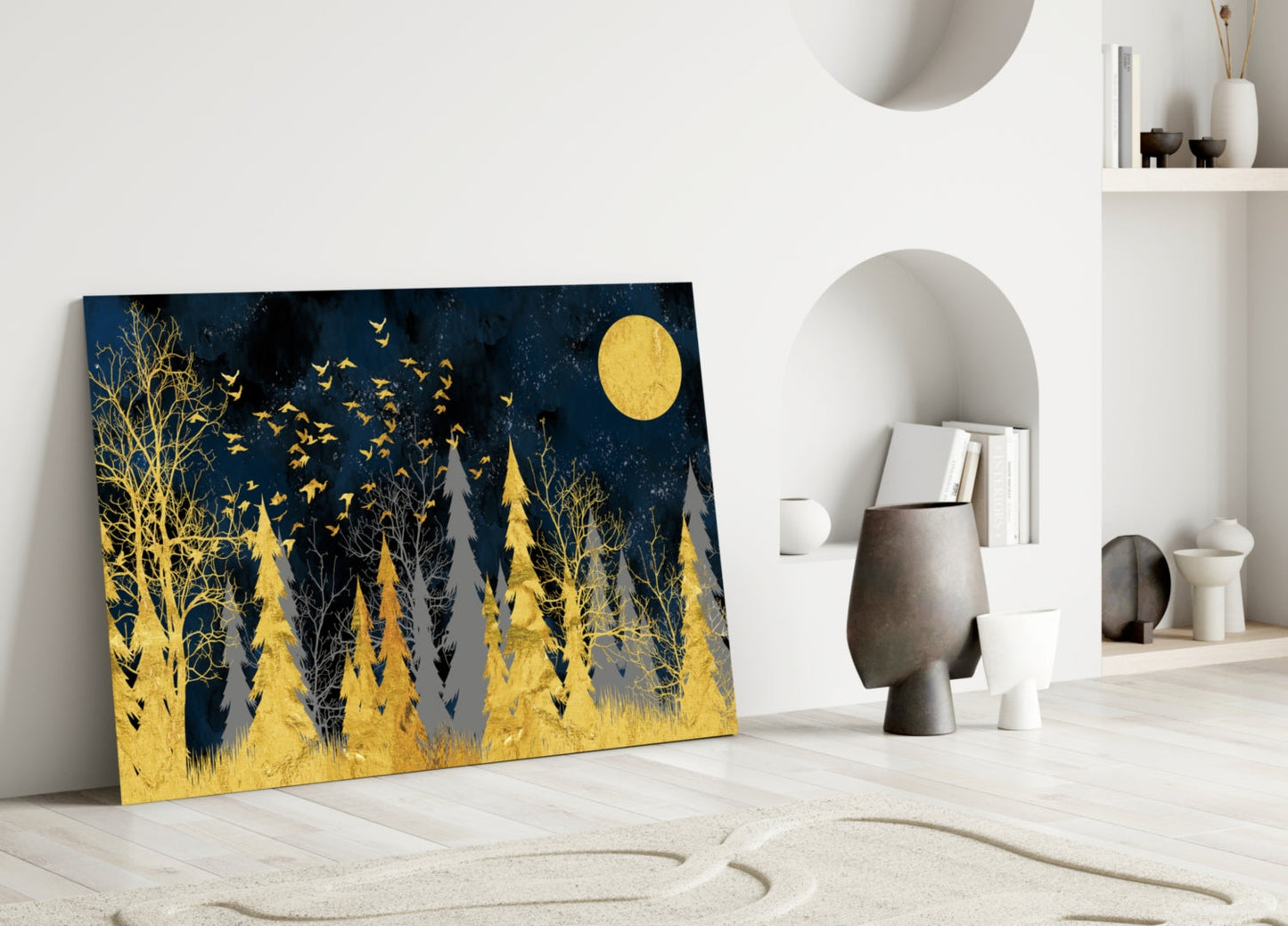 Gold and navy forest scene with yellow moon and flying birds displayed leaning against white wall in modern interior.