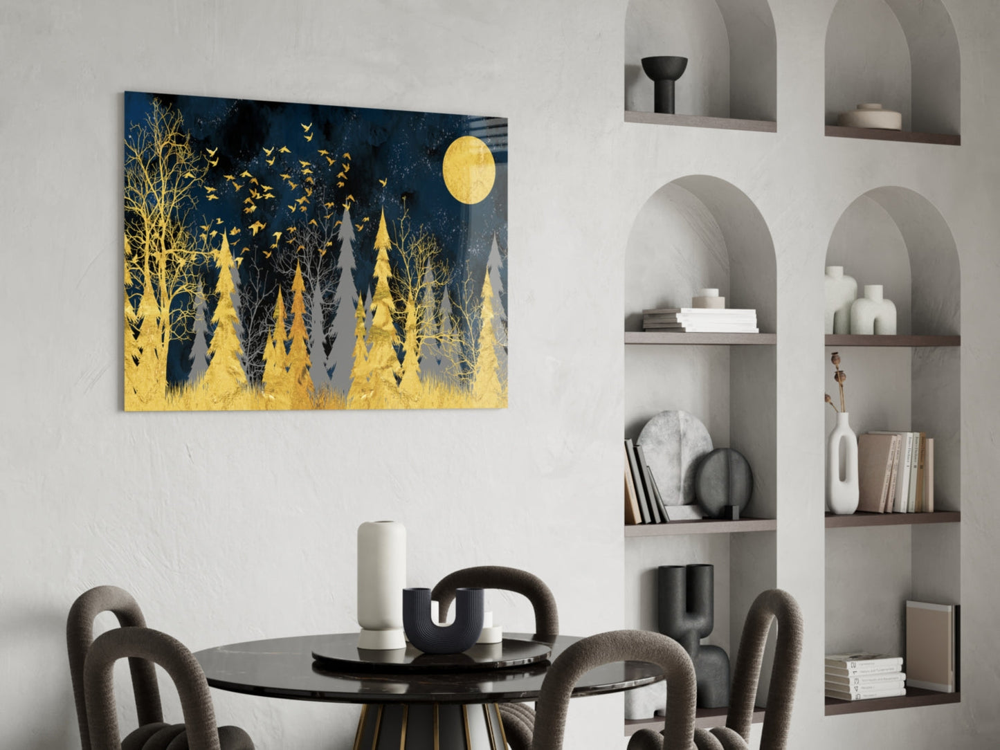 Colors of the Night glass wall art depicting golden trees and full moon against dark blue background, displayed above black dining table with gray chairs.