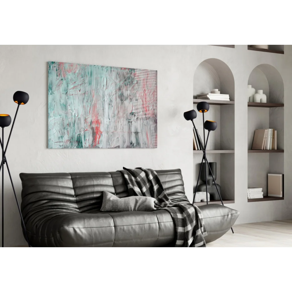 Gray leather sofa with ribbed texture and plaid blanket under teal pink gray wall art