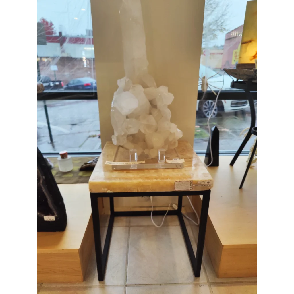 Tall translucent white crystal on Onyx Nesting Table with pointed top