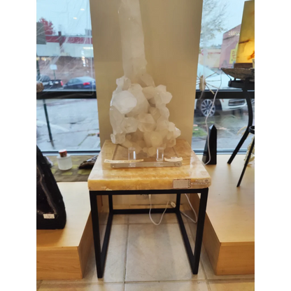 Tall translucent white crystal on Onyx Nesting Table with pointed top