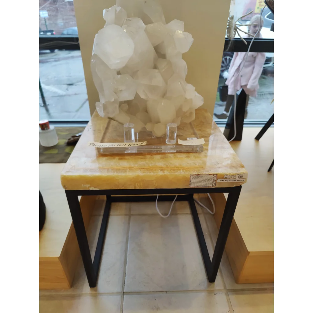 Onyx nesting table with translucent white quartz crystal cluster on yellow marble