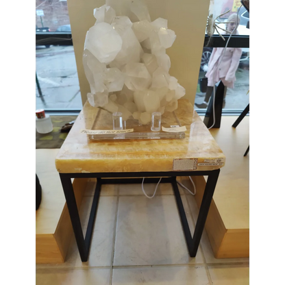 Onyx nesting table with translucent white quartz crystal cluster on yellow marble