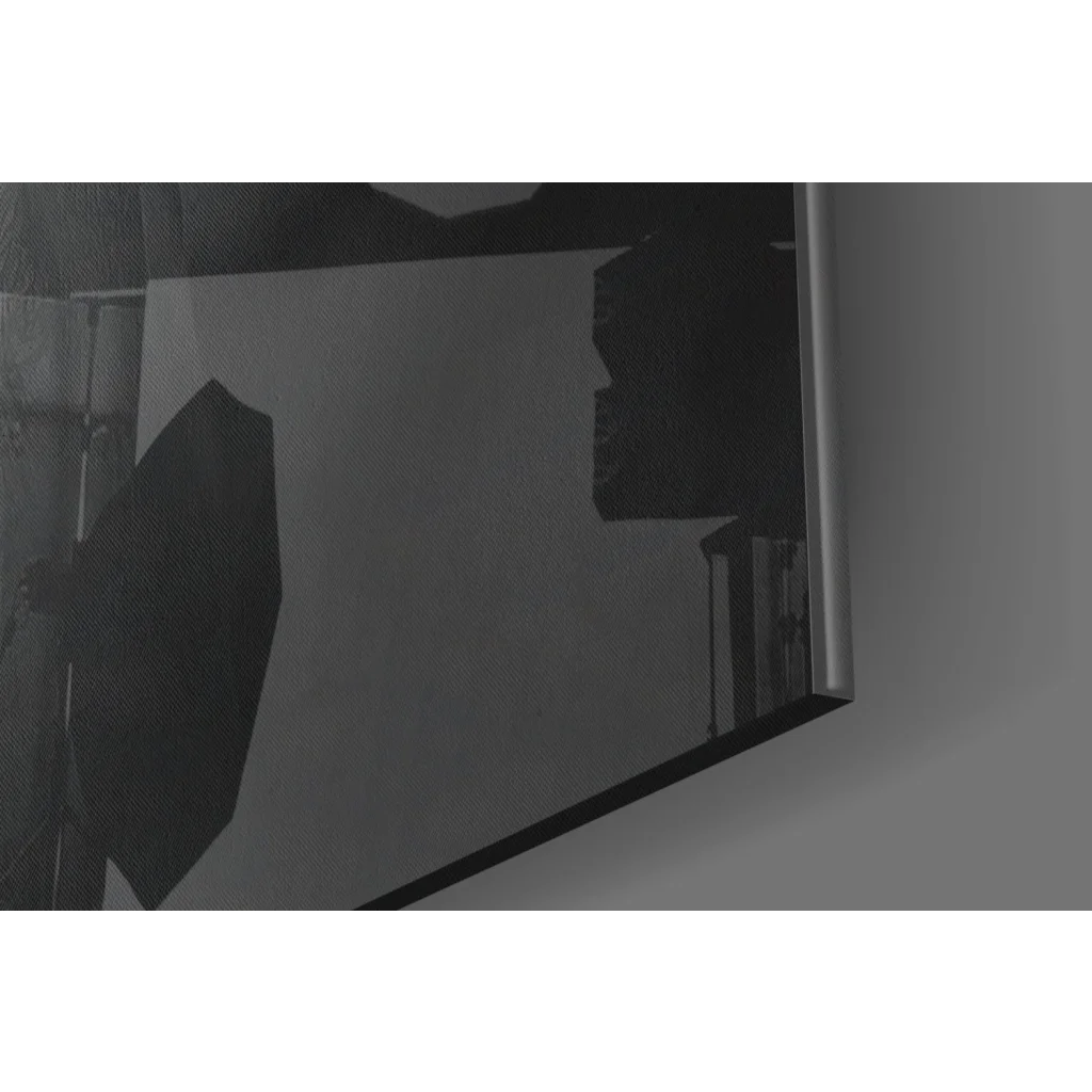 Sleek glass wall art mirror with metallic frame reflecting studio lights