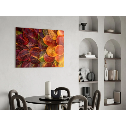Vibrant autumn leaves glass wall art in reds, oranges, golds on white wall