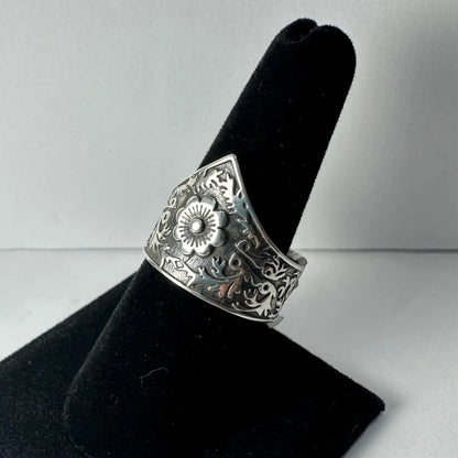Ornate silver floral garden ring with swirling vine details