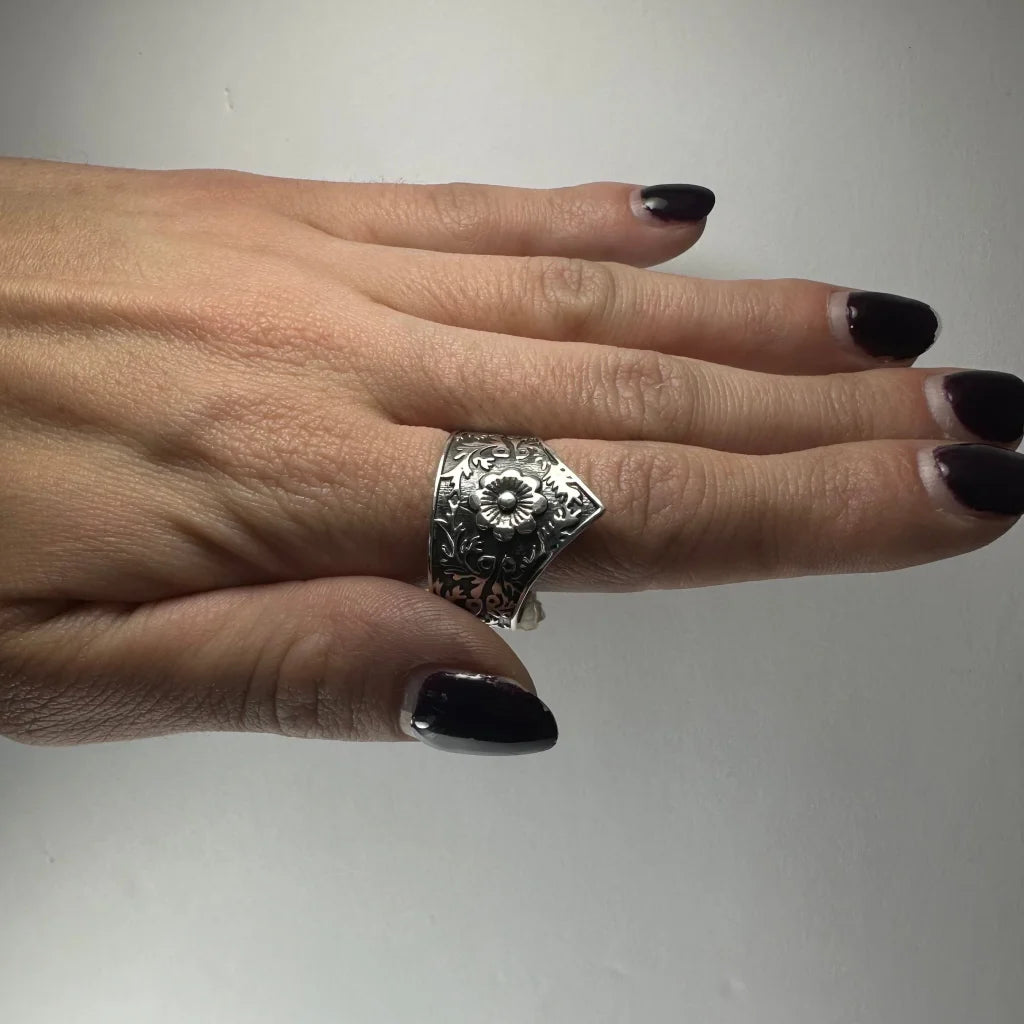 Ornate silver floral garden ring with swirling vine details