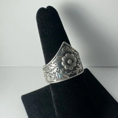 Ornate silver floral garden ring with swirling vine details