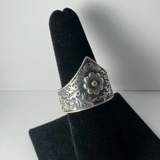 Ornate silver floral garden ring with swirling vine details
