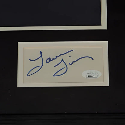 Beige rectangular card with blue ink signature and oval jsa authentication sticker from deluxe framed jason bateman laura linney poster