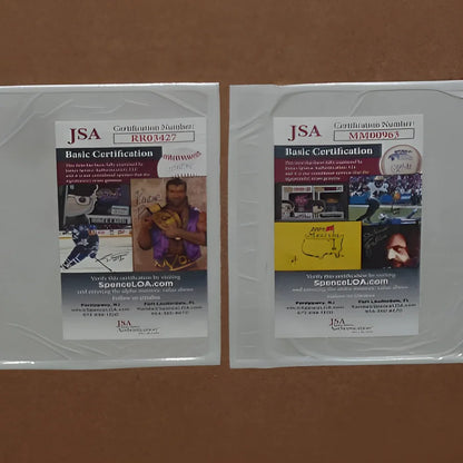 Two clear plastic-wrapped jsa basic certification cards for deluxe framed ozark tv poster autographed by jason bateman and laura linney