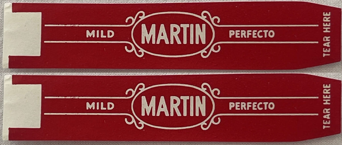 Two vintage Martin Mild Perfecto cigar bands, one above the other: MARTIN in white in an oval frame, MILD and PERFECTO either side on red, TEAR HERE printed up the pointed end.