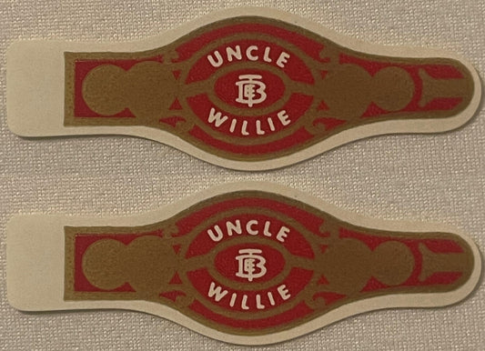 Two vintage Uncle Willie cigar bands, one above the other: UNCLE arched over a TEB monogram and WILLIE below, white on red, gold scrollwork and roundels, cream die-cut edges.
