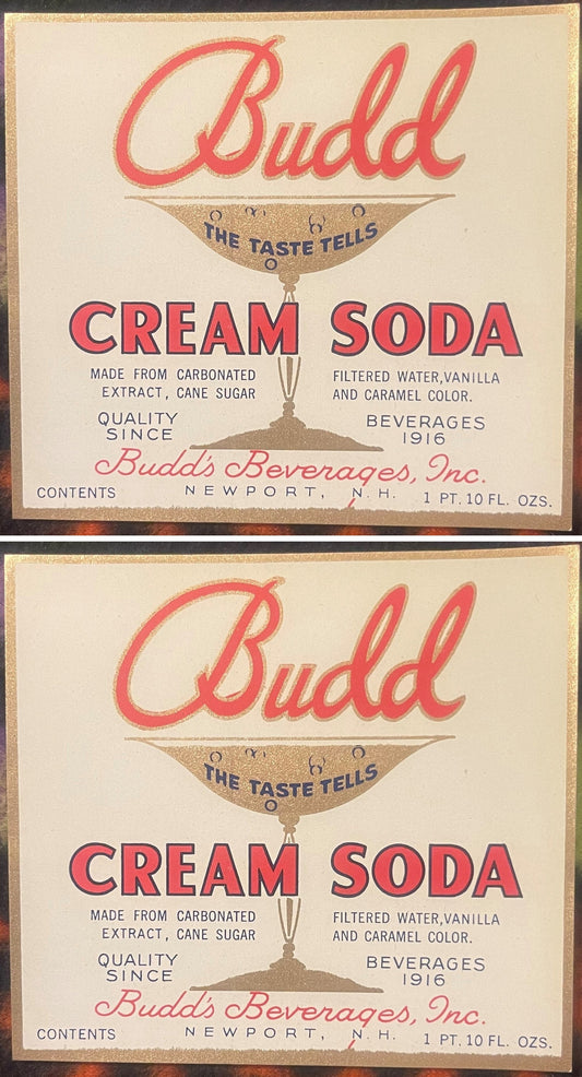 Two Budd Cream Soda labels, one above the other: red Budd script over a gold soda glass reading THE TASTE TELLS, red CREAM SODA, Budd's Beverages, Inc., Newport, N.H.