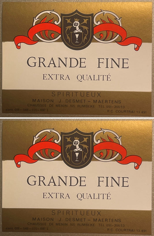 Two Grande Fine Extra Qualité spirits labels, one above the other: a dark heraldic shield between red banners on gold, Maison J. Desmet-Maertens, Rumbeke