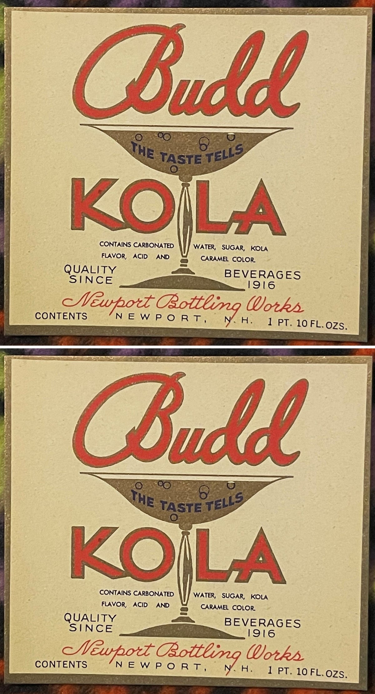 Two Budd Kola labels, one above the other: red Budd script over a gold cocktail glass reading THE TASTE TELLS, KOLA in red split by the glass stem, Newport Bottling Works, Newport, N.H.