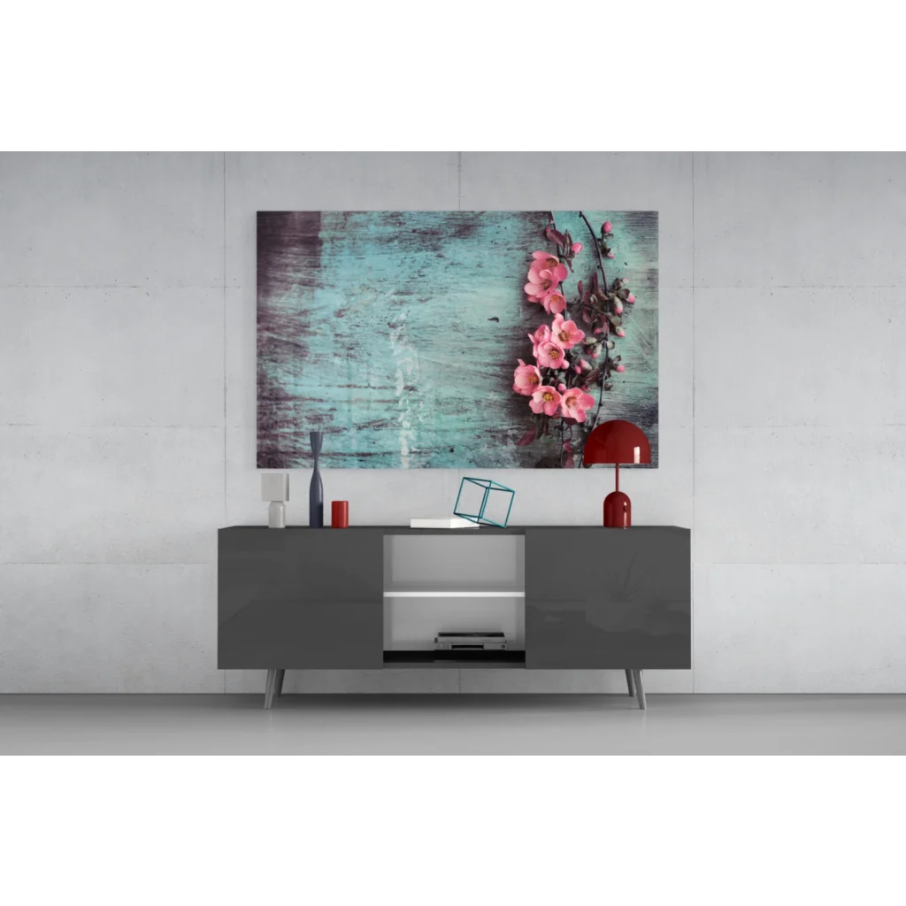 Vibrant pink blossoms on teal canvas wall art print above gray console