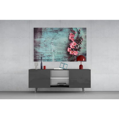Vibrant pink blossoms on teal canvas wall art print above gray console