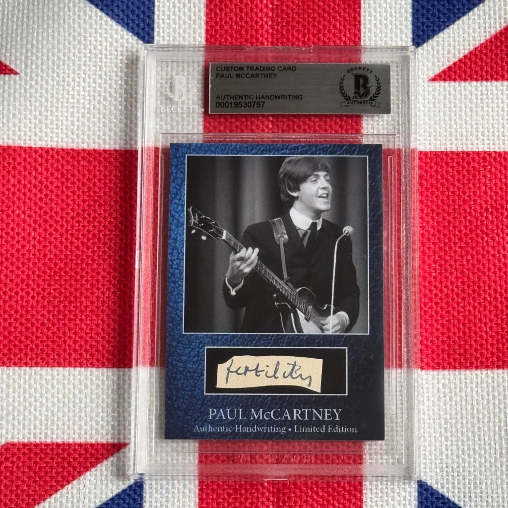 A framed custom trading card with a black and white photo of Paul McCartney and his authentic handwriting autograph