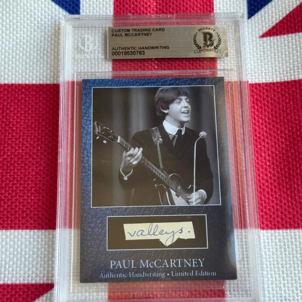 A black and white paul mccartney guitar trading card with original handwriting encased in a clear slab with beckett label