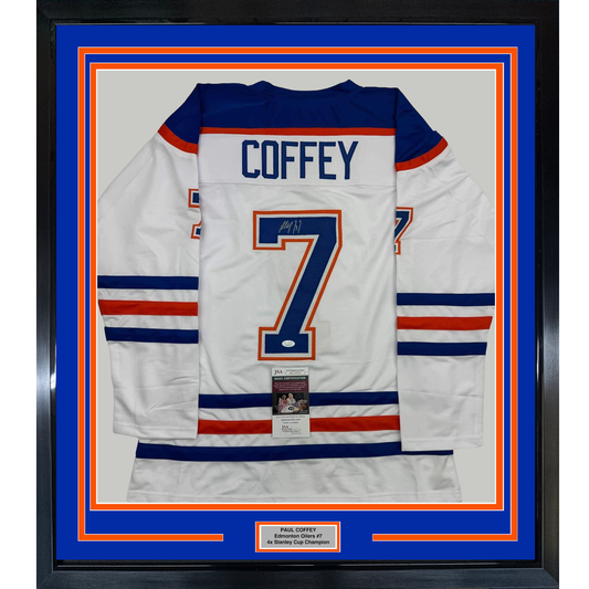 Framed white Edmonton Oilers hockey jersey number 7 with "COFFEY" nameplate and autograph, mounted on blue and orange backing with JSA certification label.
