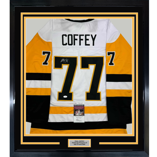 Framed Pittsburgh Penguins white hockey jersey number 77 with "COFFEY" nameplate, signed, displayed against black and gold matting with certification labels visible.