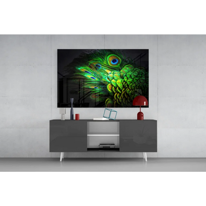Vibrant green peacock feather glass wall art with iridescent eyes on black wall