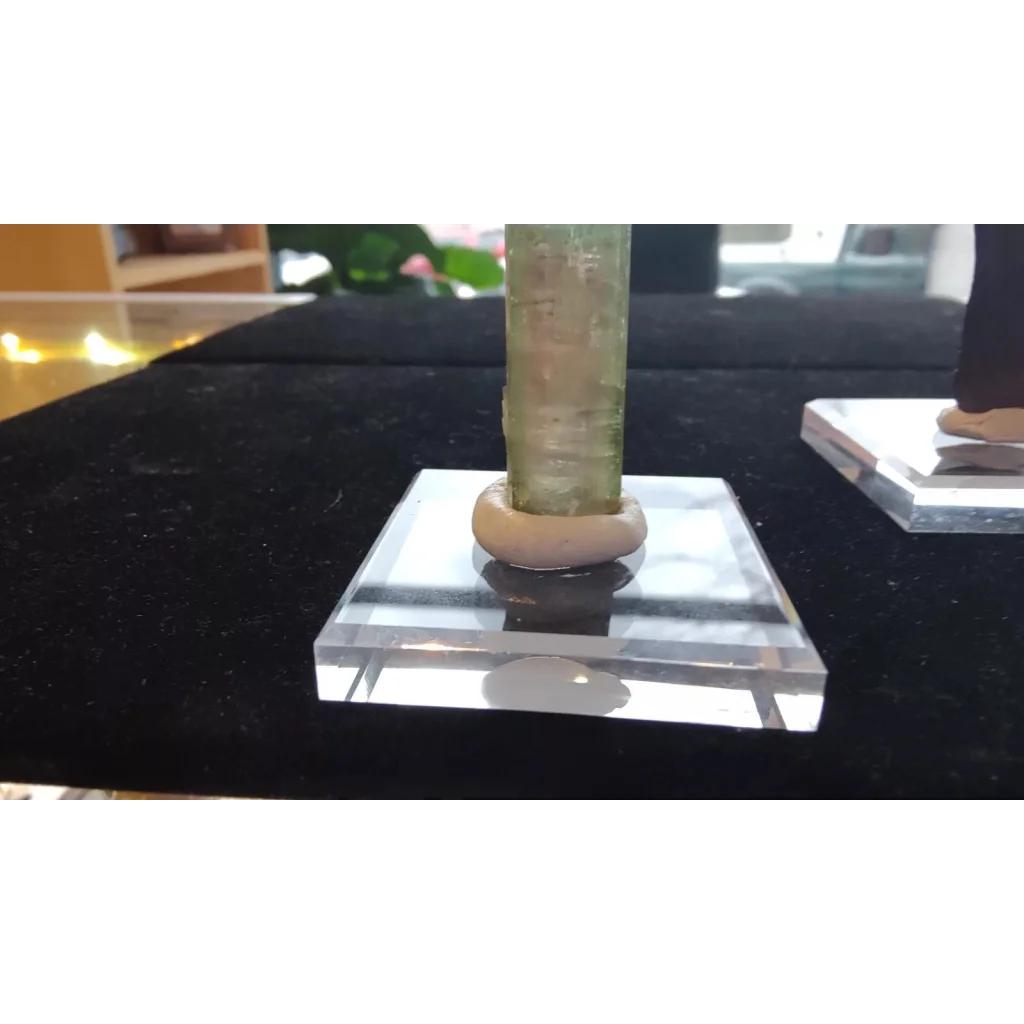 Translucent green crystal on display putty for collectibles