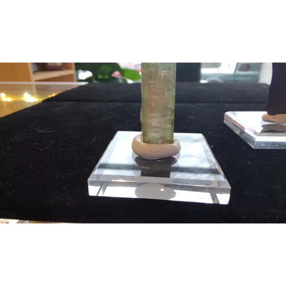 Translucent green crystal on display putty for collectibles