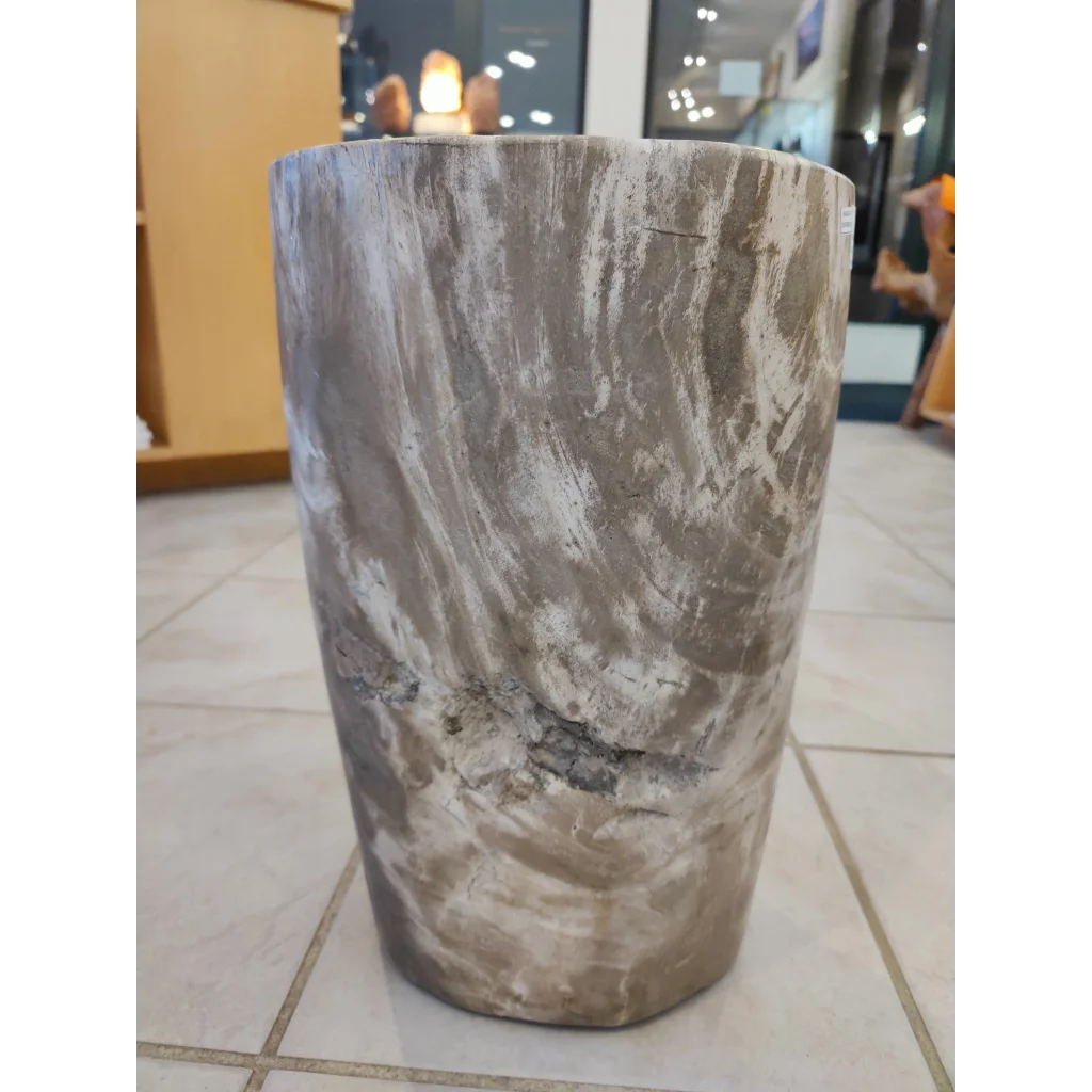 Petrified wood pedestal side table with swirling gray and white pattern