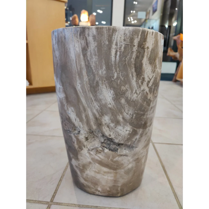 Petrified wood pedestal side table with swirling gray and white pattern