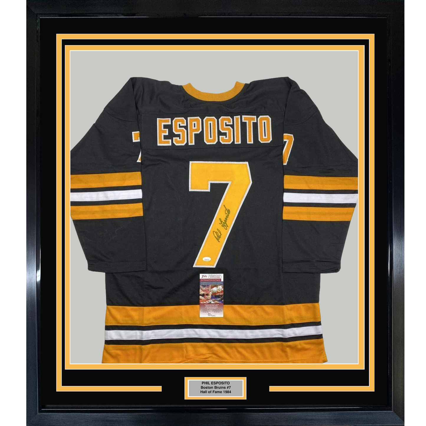 Black and gold Boston Bruins jersey #7 signed by Phil Esposito, displayed flat in framed mount with JSA authentication certificate visible.