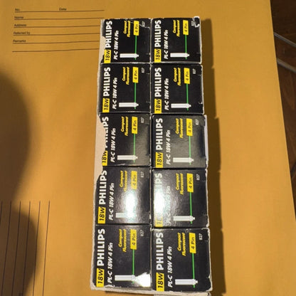 Sixteen Philips 18W PL-C 830 lamp bulbs in black boxes, 10-pack display