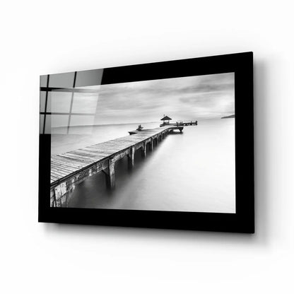 Black-and-white glass wall art of wooden pier in calm water