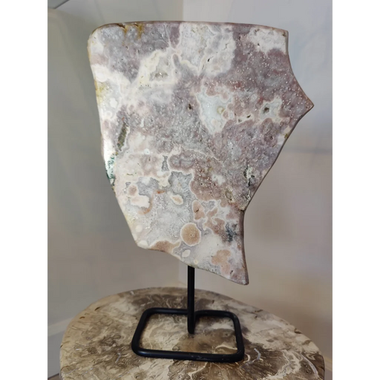 Pink amethyst polished slab sculpture with swirling white gray and pink hues on a black metal display stand weighing 3.16kg