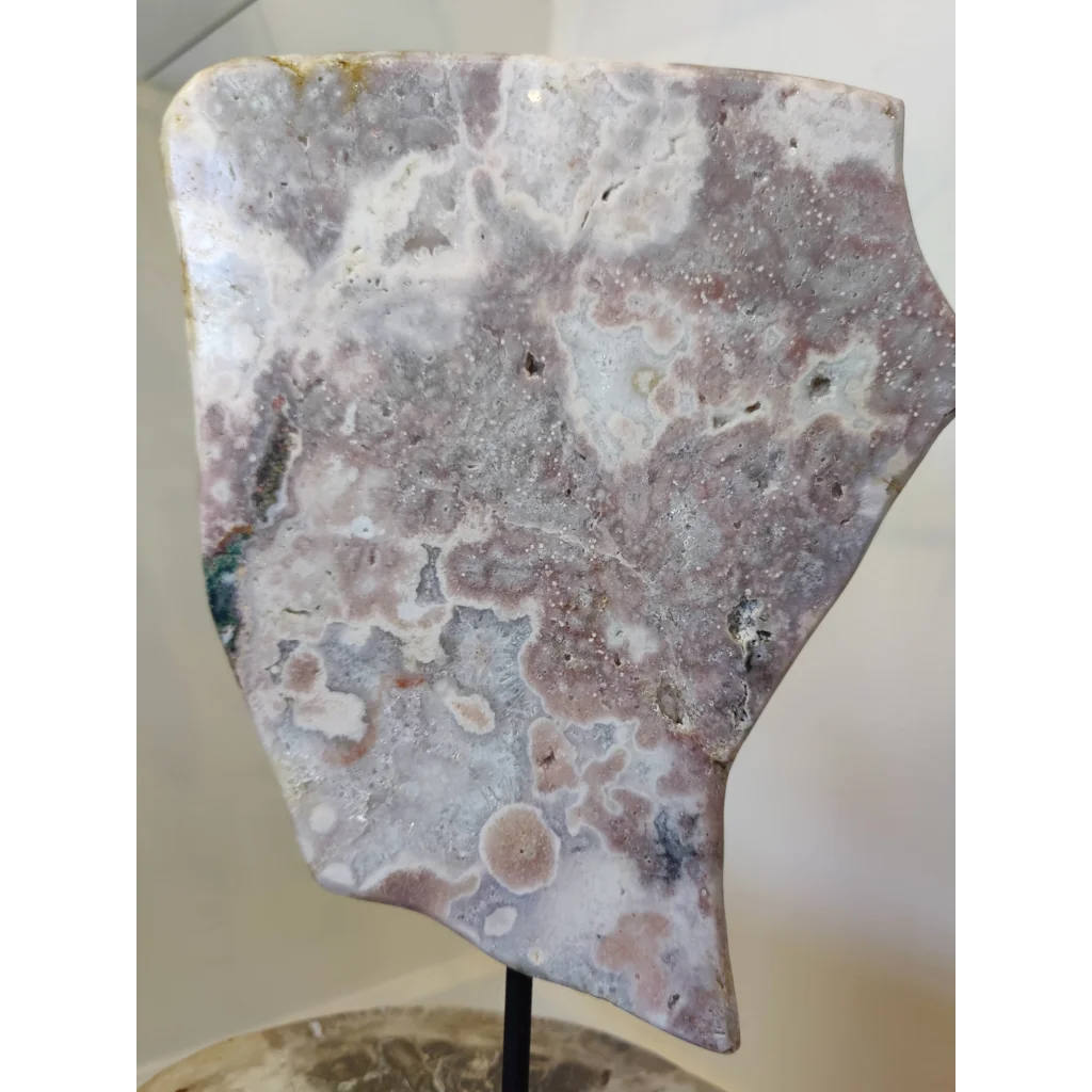 Pink amethyst polished slab sculpture featuring a polished irregular rose quartz piece with soft pink and white swirls on metal stand