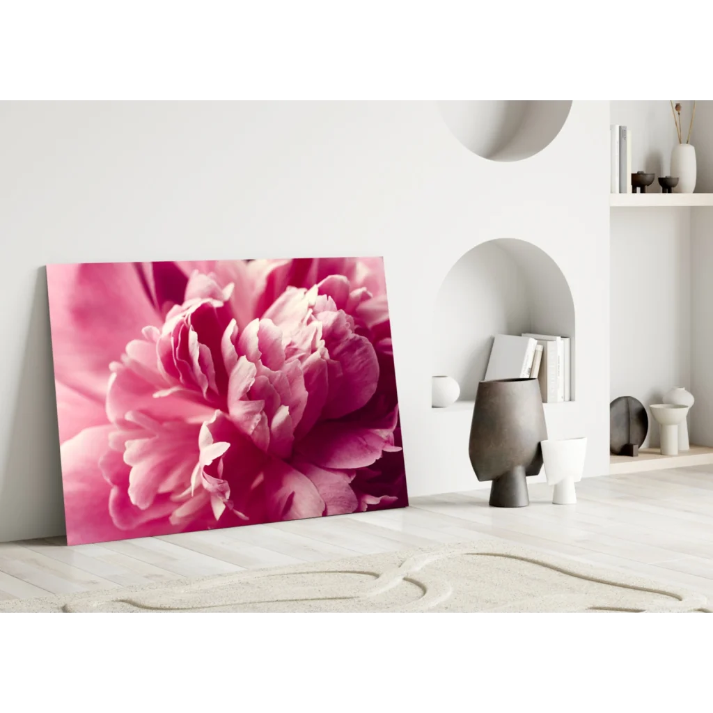 Vibrant pink peony canvas wall art leaning against white wall