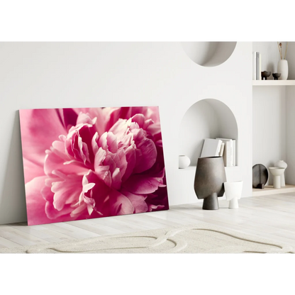 Vibrant pink peony canvas wall art leaning against white wall