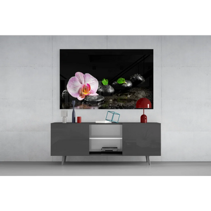 Pink orchid zen garden wall art on black stones with green leaves