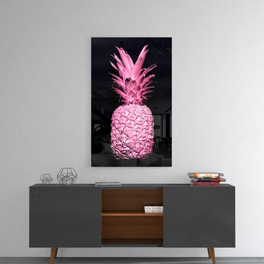 Vibrant pink pineapple glass wall art on black canvas, glossy finish above gray console