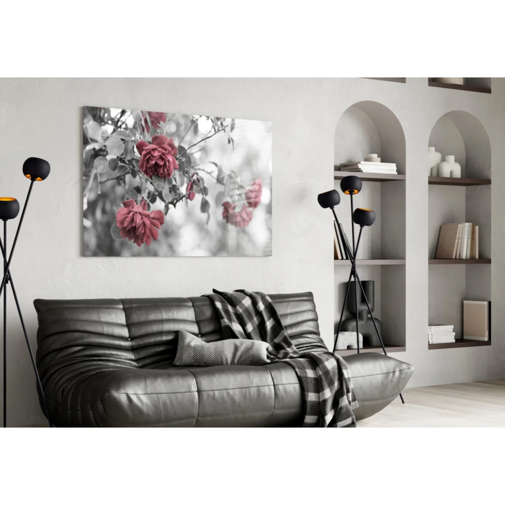 Modern black leather sofa with plaid throw and pink roses wall art