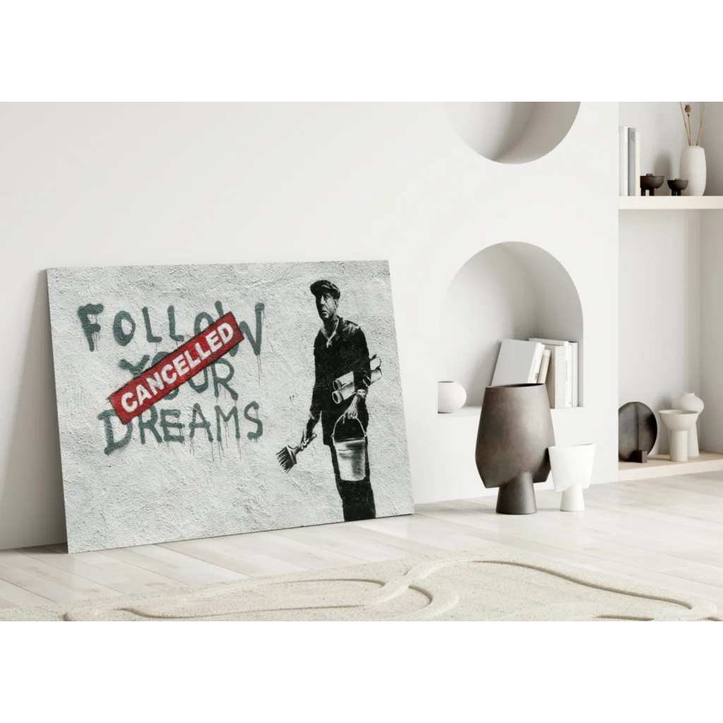 Banksy Dreams Cancelled wall art: gray canvas stencil of worker with bucket and broom, dreams text crossed out